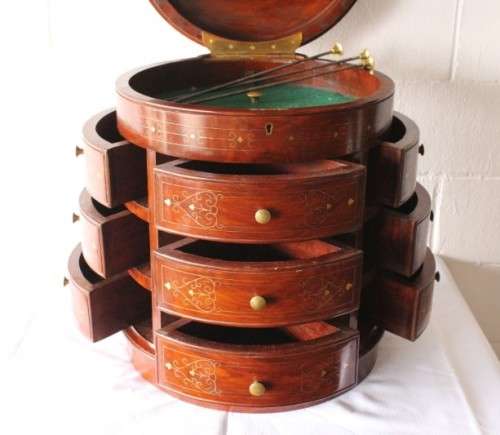 A spectacular and beautifully made solid rosewood round 12-drawer jewellery chest with brass inlay