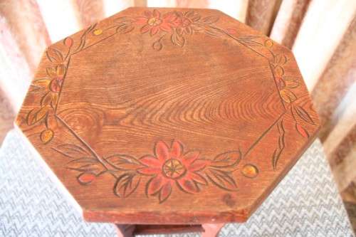 A gorgeous carved round occasional/ side table w/ painted detail on the top and bottom shelf base.