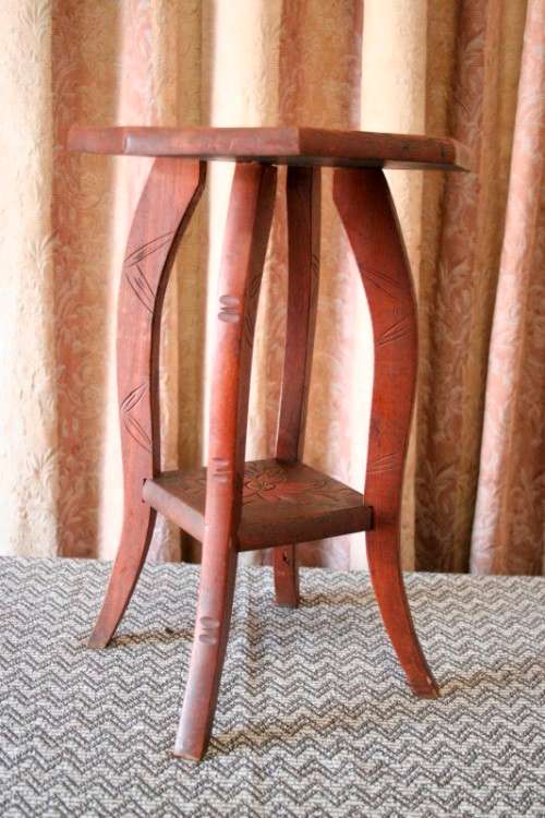 A gorgeous carved round occasional/ side table w/ painted detail on the top and bottom shelf base.