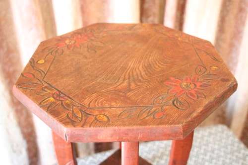 A gorgeous carved round occasional/ side table w/ painted detail on the top and bottom shelf base.