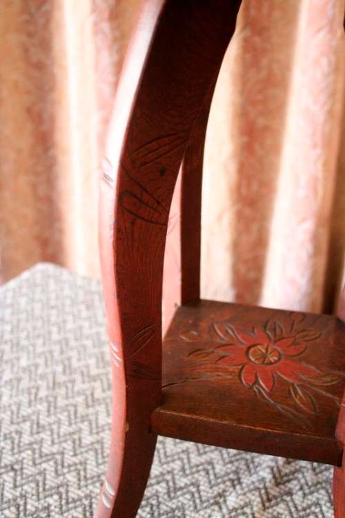 A gorgeous carved round occasional/ side table w/ painted detail on the top and bottom shelf base.