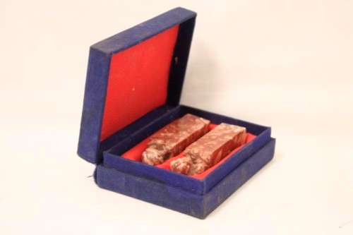 An incredible boxed pair of hand carved red-marble Feng Shui Foo Dog/ Temple Lion ornaments