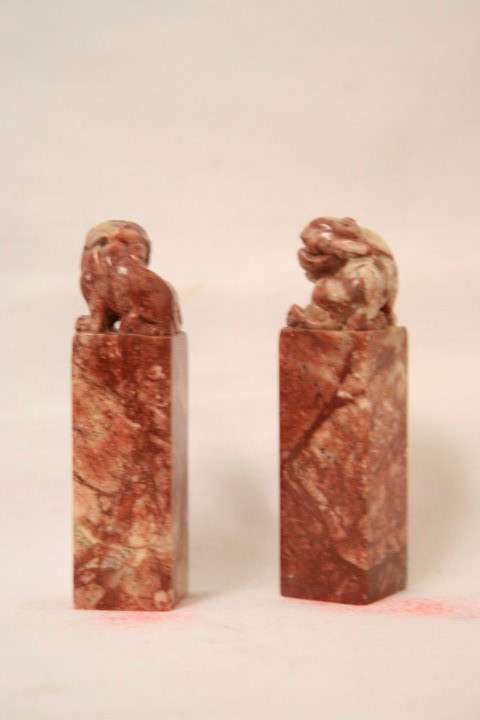 An incredible boxed pair of hand carved red-marble Feng Shui Foo Dog/ Temple Lion ornaments