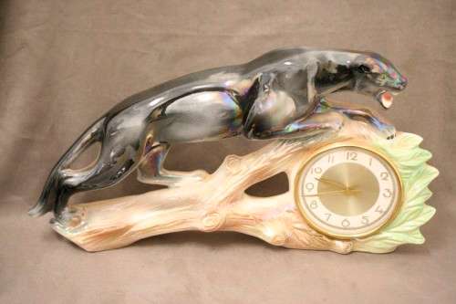 A gorgeous, decorative German made porcelain Jaguar wind up clock.