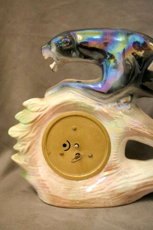 A gorgeous, decorative German made porcelain Jaguar wind up clock.