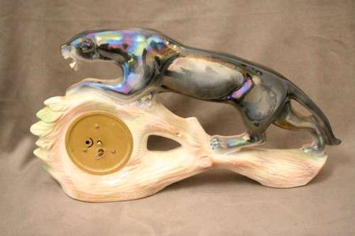 A gorgeous, decorative German made porcelain Jaguar wind up clock.