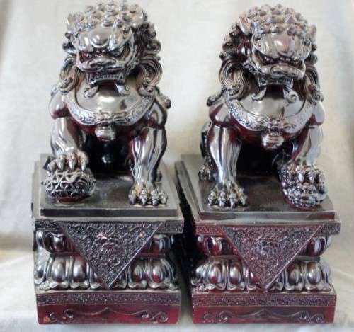 A spectacular pair of Oriental large red resin foo dogs/ temple lions in stunning condition.