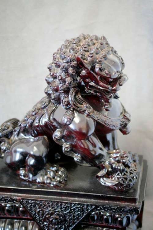 A spectacular pair of Oriental large red resin foo dogs/ temple lions in stunning condition.