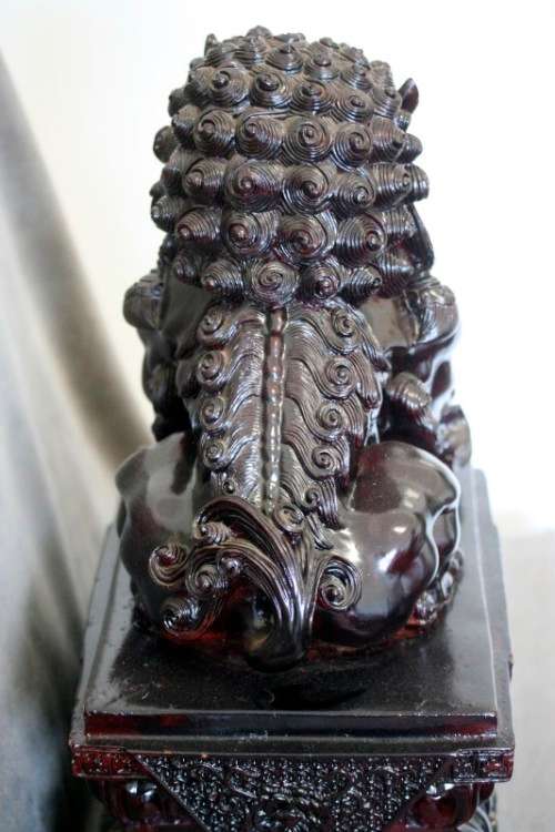 A spectacular pair of Oriental large red resin foo dogs/ temple lions in stunning condition.