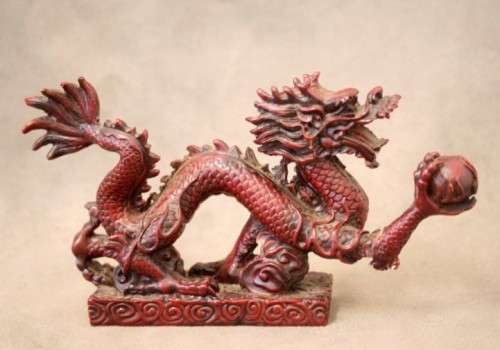 A fabulous red resin Oriental dragon figurine. Stunning on display