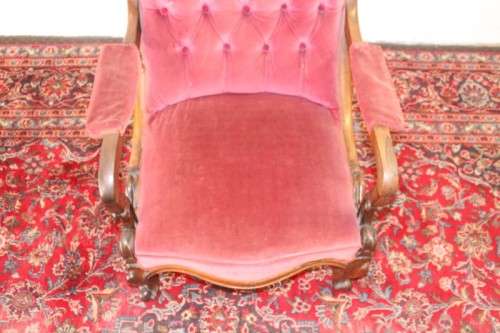 A stunningly hand carved antique walnut "Art Nouveau" reading chair with deep button detailing