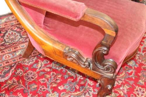 A stunningly hand carved antique walnut "Art Nouveau" reading chair with deep button detailing