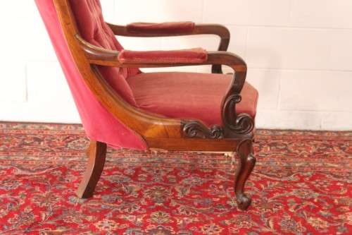 A stunningly hand carved antique walnut "Art Nouveau" reading chair with deep button detailing