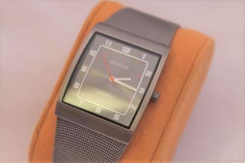 An incredible Bering "Classic" Titanium Slim men's watch with an adjustable black mesh strap