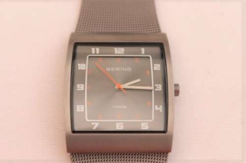 An incredible Bering "Classic" Titanium Slim men's watch with an adjustable black mesh strap