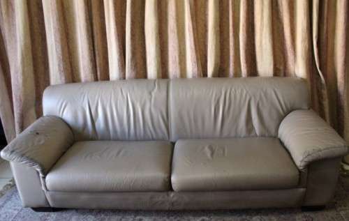 A lovely well made (235cm long) beige faux leather couch. Perfect in informal rooms, lapa etc