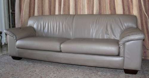 A lovely well made (235cm long) beige faux leather couch. Perfect in informal rooms, lapa etc