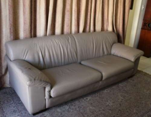 A lovely well made (235cm long) beige faux leather couch. Perfect in informal rooms, lapa etc