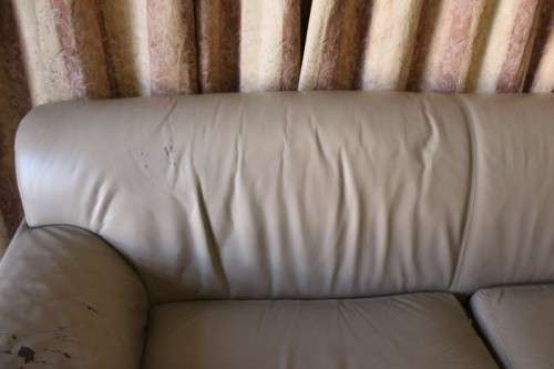 A lovely well made (235cm long) beige faux leather couch. Perfect in informal rooms, lapa etc