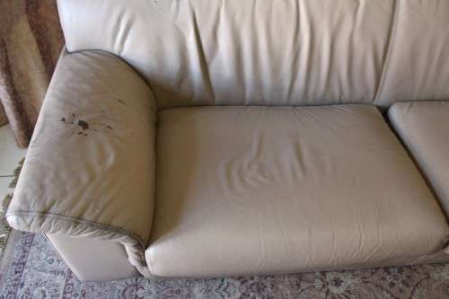 A lovely well made (235cm long) beige faux leather couch. Perfect in informal rooms, lapa etc