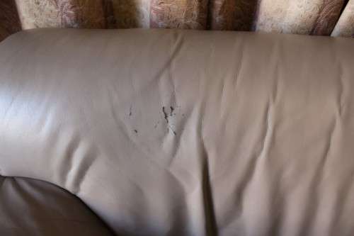 A lovely well made (235cm long) beige faux leather couch. Perfect in informal rooms, lapa etc