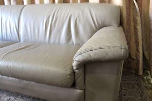 A lovely well made (235cm long) beige faux leather couch. Perfect in informal rooms, lapa etc
