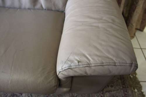 A lovely well made (235cm long) beige faux leather couch. Perfect in informal rooms, lapa etc