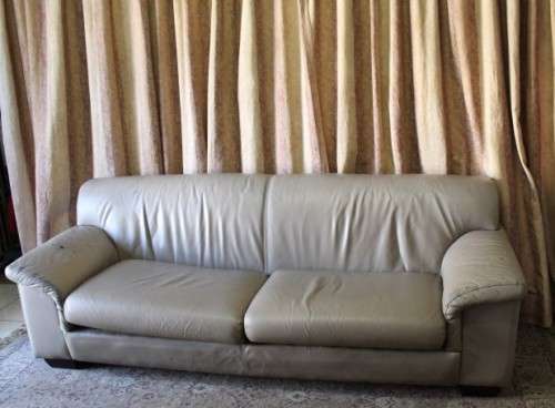 A lovely well made (235cm long) beige faux leather couch. Perfect in informal rooms, lapa etc