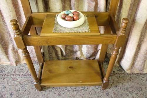 A gorgeous light wood hall stand with a coloured stained glass top, centre mirror and storage drawer