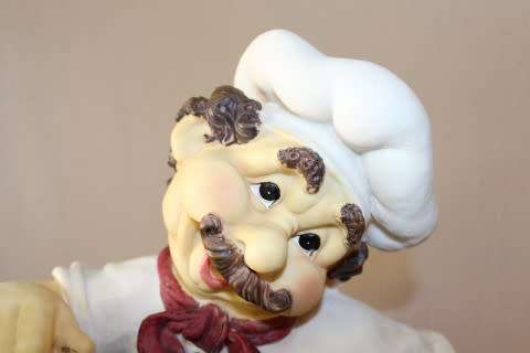 A magnificent hand crafted resin mold, hand painted menu holding chef statue. Amazing display piece