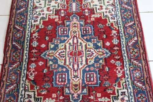 A stunning 95cm x 153cm hand knotted thick pile Persian carpet in dark reds. Gorgeous in all rooms!