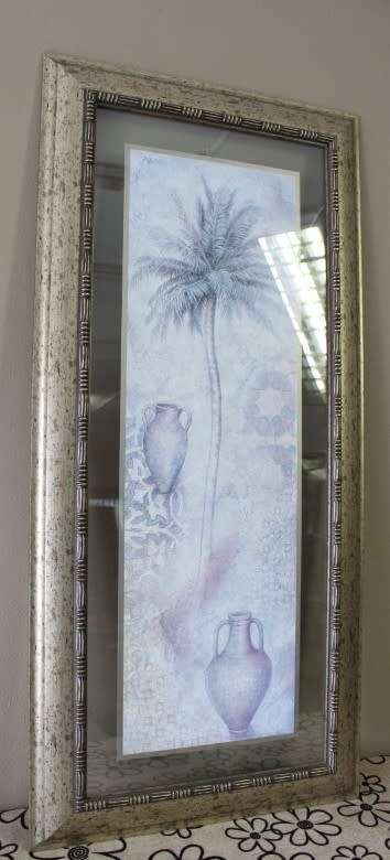 A beautifully composed print of a palm tree framed between glass in a mod wood frame Lifespace Sale