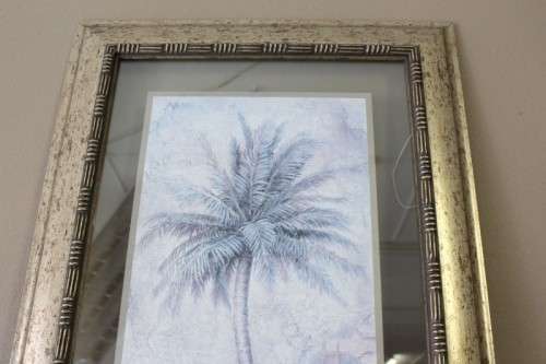 A beautifully composed print of a palm tree framed between glass in a mod wood frame Lifespace Sale