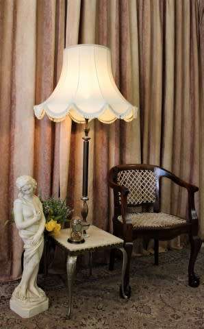 A beautiful decorative marble and brass free standing floor lamp with a large shade.