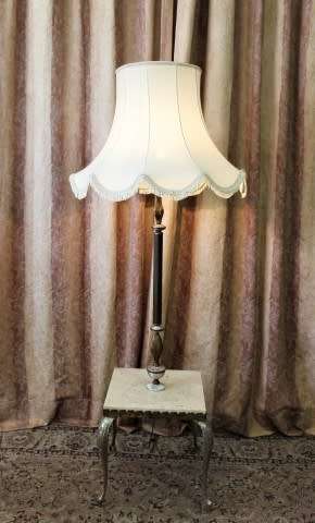 A beautiful decorative marble and brass free standing floor lamp with a large shade.