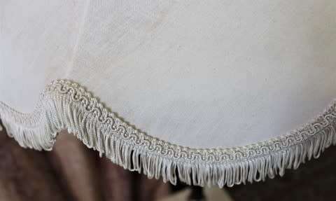 A beautiful decorative marble and brass free standing floor lamp with a large shade.