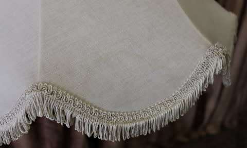 A beautiful decorative marble and brass free standing floor lamp with a large shade.