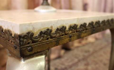 A beautiful decorative marble and brass free standing floor lamp with a large shade.