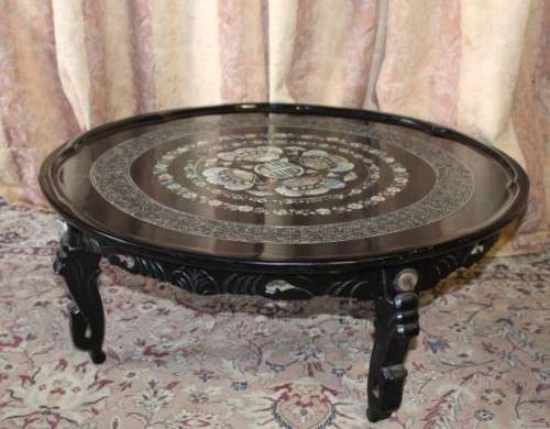 A stunning round Chinese black laquer coffee table with mother of pearl inlay top. Beautiful!!!