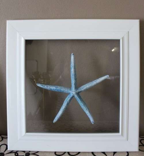 A fabulous set of real "Starfish" on a glass panel in a white frame. Stunning in all homes!!