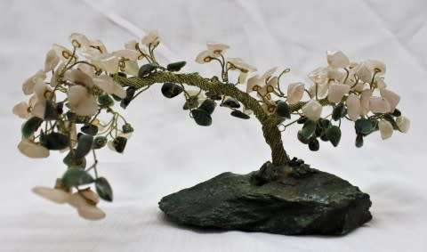A stunning moonstone & adventurine gemstone and brass tree on a green quartz base.