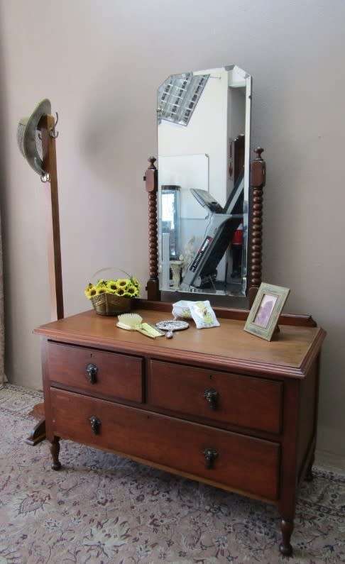 An amazing vintage Oak dressing table with a tilting bevelled centre mirror and three drawers.