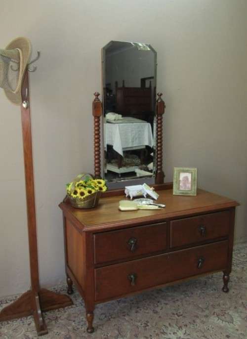 An amazing vintage Oak dressing table with a tilting bevelled centre mirror and three drawers.