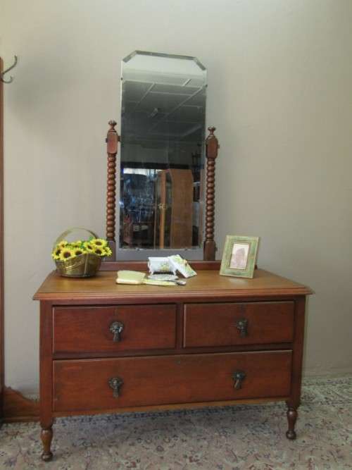 An amazing vintage Oak dressing table with a tilting bevelled centre mirror and three drawers.
