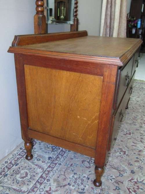 An amazing vintage Oak dressing table with a tilting bevelled centre mirror and three drawers.