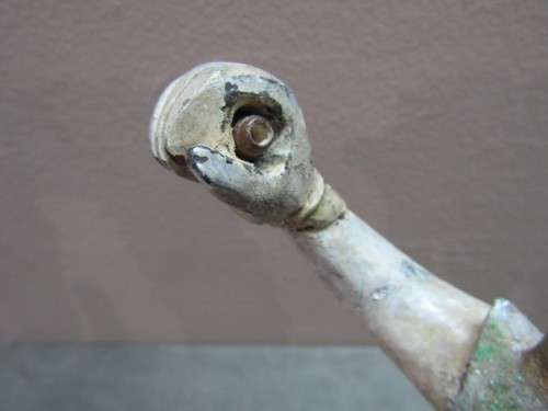 A carved ornamental Oriental wood figurine in traditional dress on a wood base. Lifespace Sale