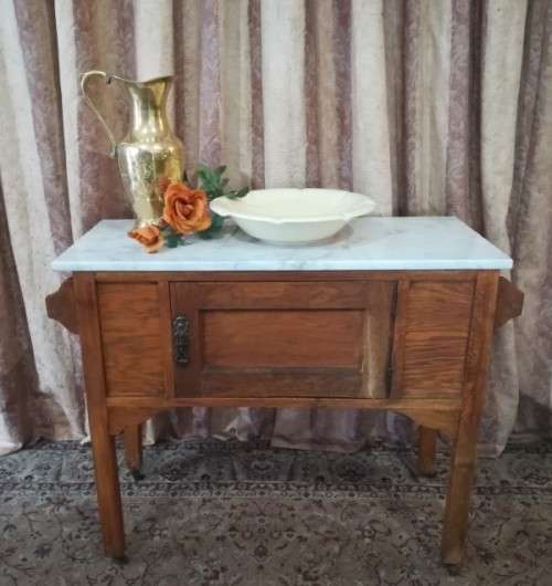 A wonderful vintage solid Oak single door wash stand with a white marble top on castors - stunning!!