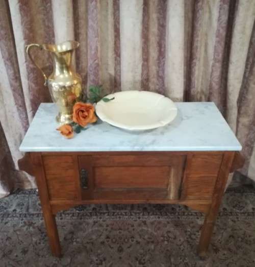 A wonderful vintage solid Oak single door wash stand with a white marble top on castors - stunning!!
