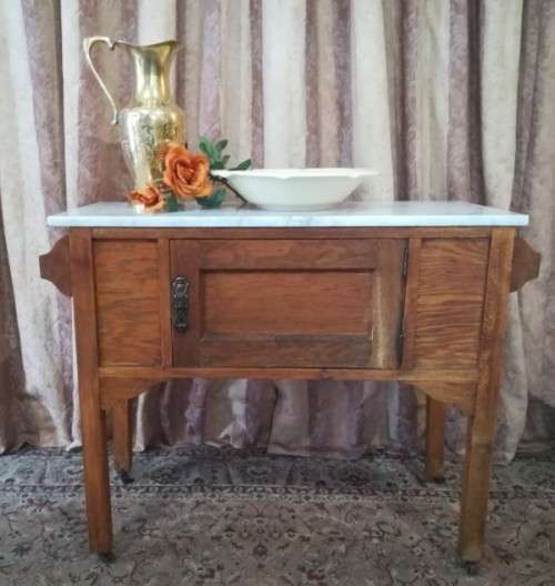 A wonderful vintage solid Oak single door wash stand with a white marble top on castors - stunning!!
