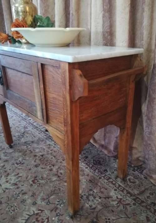 A wonderful vintage solid Oak single door wash stand with a white marble top on castors - stunning!!